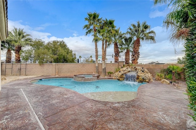 view of pool featuring a patio area, a pool with connected hot tub, and a fenced backyard