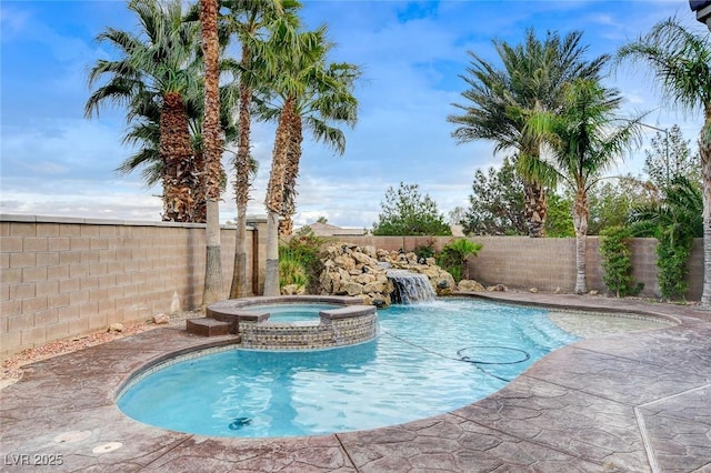 view of pool with a pool with connected hot tub and a fenced backyard