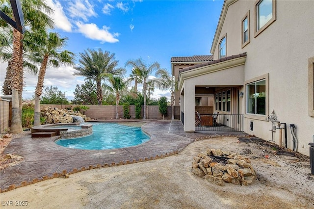 view of pool featuring a fenced backyard, a pool with connected hot tub, and a patio