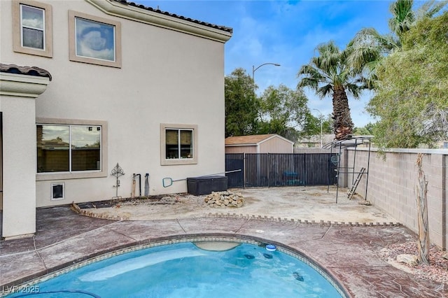 view of swimming pool with a patio and a fenced backyard