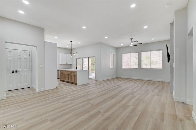 unfurnished living room featuring recessed lighting, a ceiling fan, and light wood-style floors