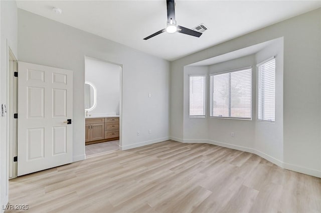 unfurnished bedroom with visible vents, light wood-style flooring, ensuite bathroom, and baseboards