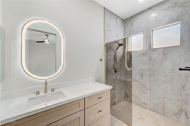 bathroom with a marble finish shower and vanity