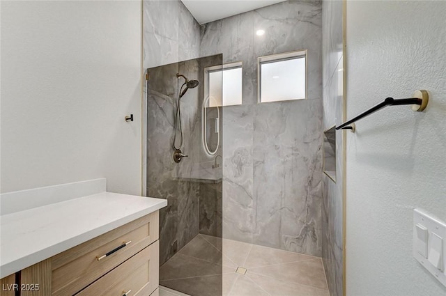 bathroom featuring a marble finish shower