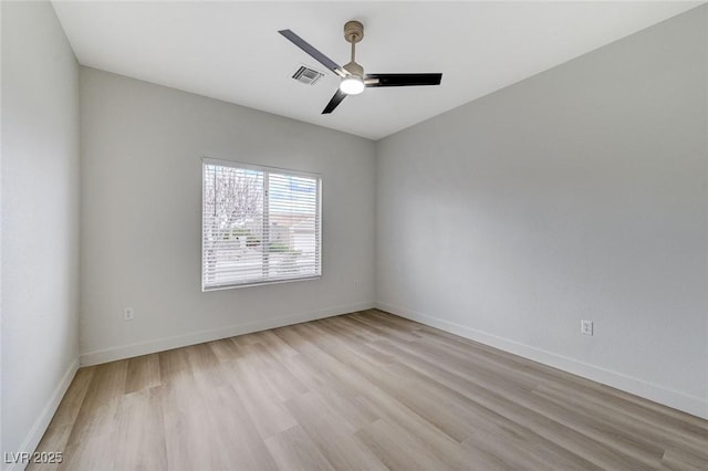 unfurnished room with a ceiling fan, baseboards, visible vents, and light wood-type flooring