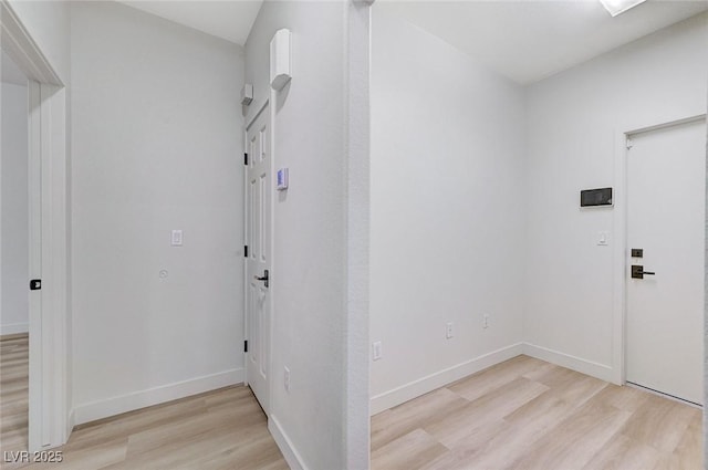 interior space with light wood-style floors and baseboards