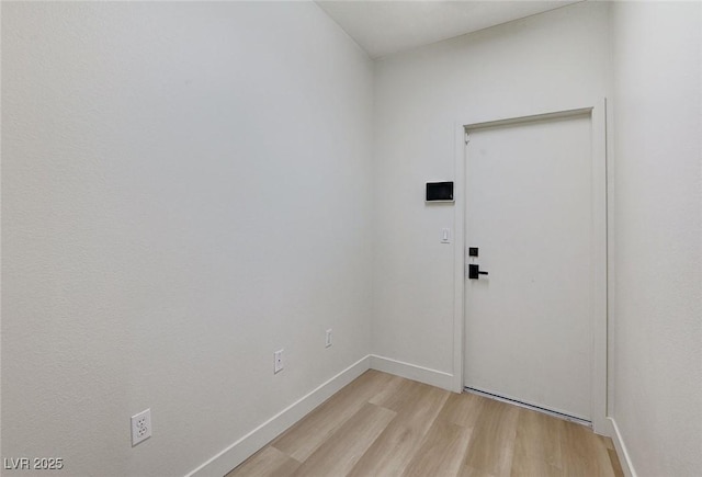 interior space with baseboards and light wood-style floors