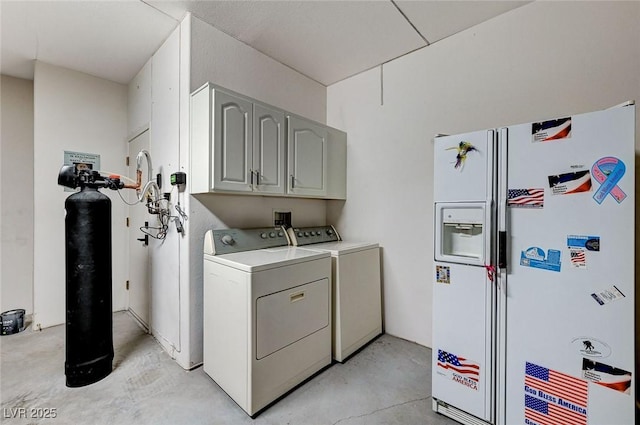 clothes washing area featuring cabinet space and washer and dryer