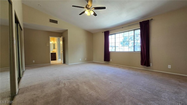 unfurnished bedroom with baseboards, visible vents, lofted ceiling, and light carpet