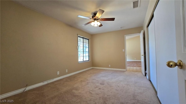 unfurnished bedroom with visible vents, a ceiling fan, a closet, baseboards, and light colored carpet