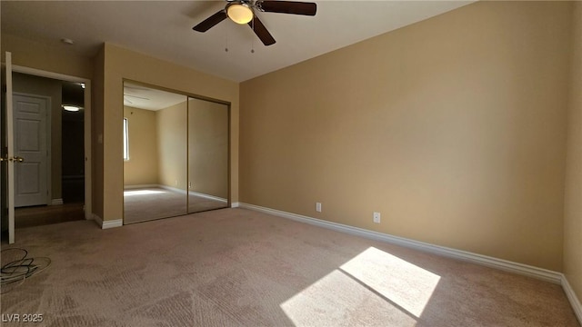 unfurnished bedroom featuring a closet, carpet flooring, ceiling fan, and baseboards