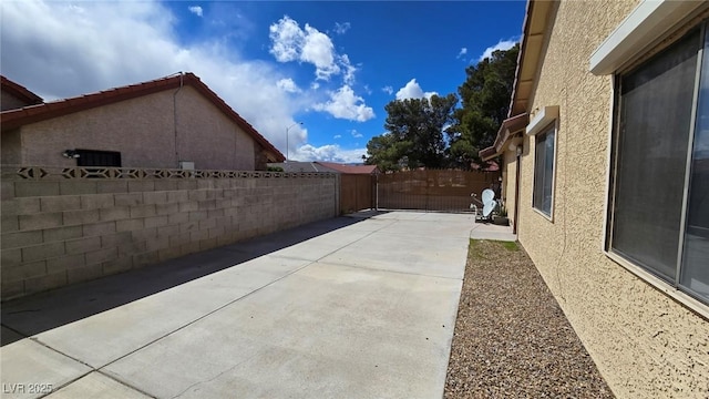 view of patio featuring a gate and fence