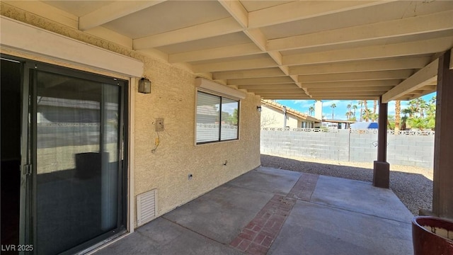 view of patio featuring fence and visible vents