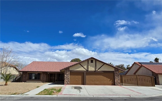 ranch-style house with a tile roof, stucco siding, a garage, stone siding, and driveway