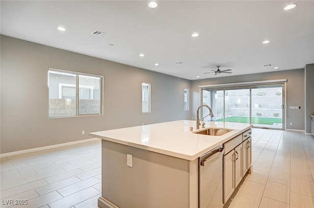 kitchen with a center island with sink, recessed lighting, a sink, stainless steel dishwasher, and open floor plan