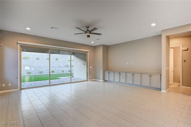 spare room featuring recessed lighting, visible vents, and baseboards