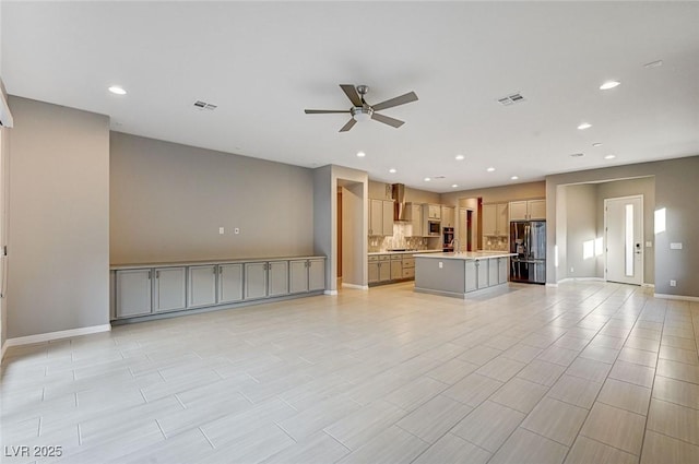 unfurnished living room featuring recessed lighting, a ceiling fan, and visible vents