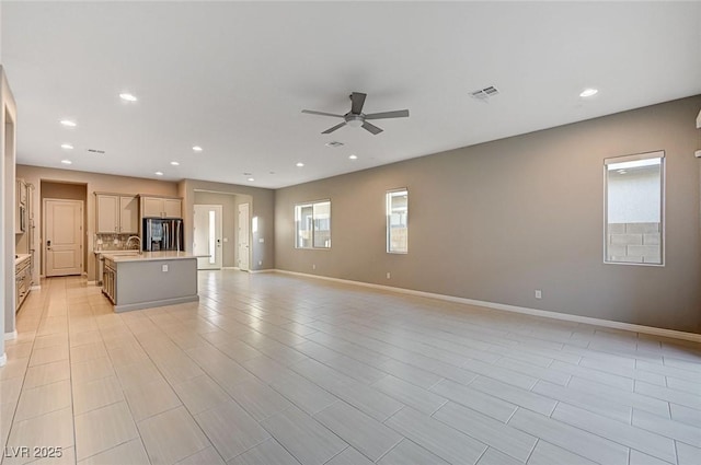 unfurnished living room with visible vents, recessed lighting, baseboards, and a ceiling fan