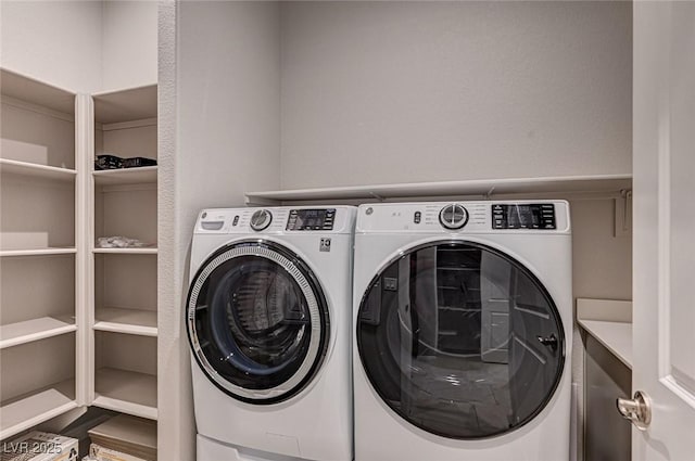 clothes washing area with washer and dryer and laundry area