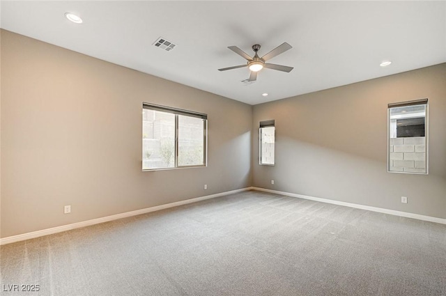 carpeted empty room featuring recessed lighting and baseboards