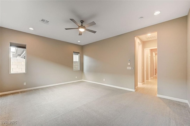 carpeted empty room with visible vents, recessed lighting, a ceiling fan, and baseboards