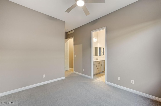 unfurnished room with baseboards, light carpet, and a ceiling fan