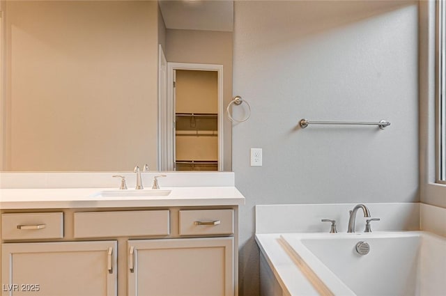 bathroom featuring a washtub and vanity