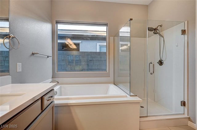 bathroom with a bath, a shower stall, and vanity