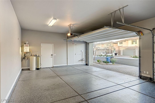 garage with a garage door opener, water heater, and baseboards