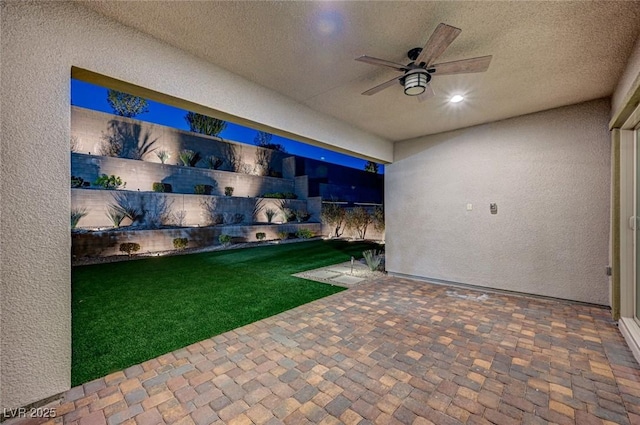 view of patio featuring ceiling fan