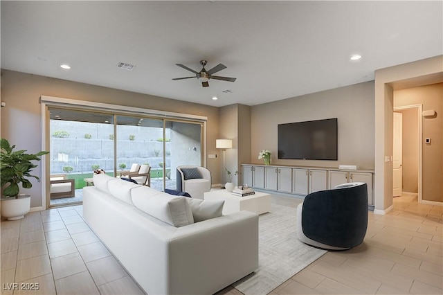 living area featuring a ceiling fan, visible vents, baseboards, light tile patterned flooring, and recessed lighting