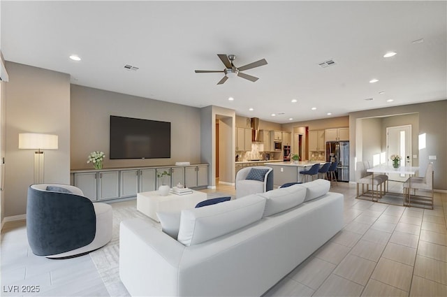 living area featuring a ceiling fan, recessed lighting, visible vents, and baseboards