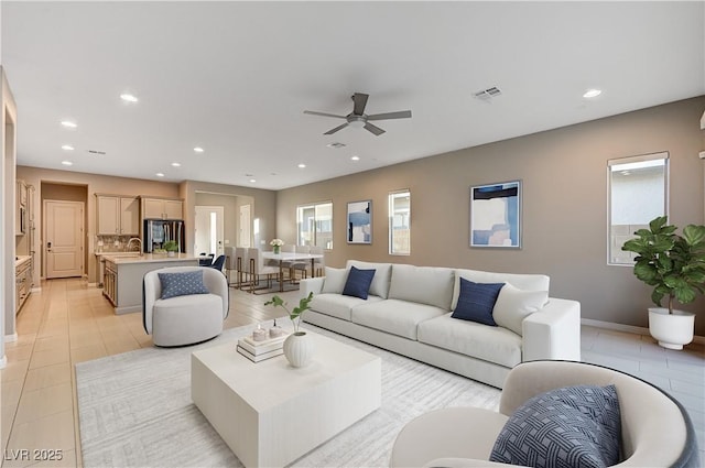 living room with light tile patterned floors, visible vents, a ceiling fan, and recessed lighting