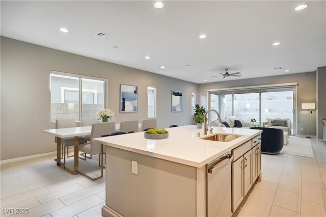 kitchen featuring a center island with sink, recessed lighting, a sink, stainless steel dishwasher, and open floor plan