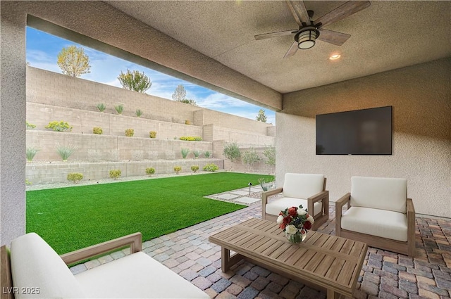 view of patio / terrace featuring an outdoor living space, a fenced backyard, and ceiling fan