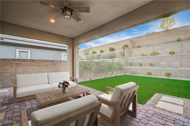 view of patio featuring an outdoor living space, a fenced backyard, and ceiling fan