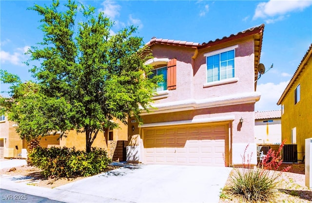 view of front of home featuring stucco siding, driveway, an attached garage, and a tile roof