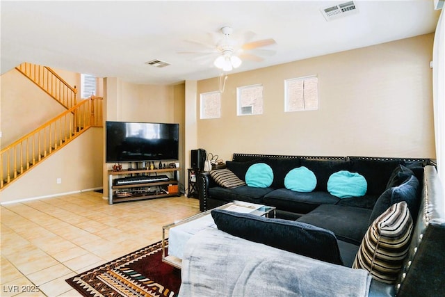 living room featuring stairs, visible vents, a ceiling fan, and tile patterned flooring