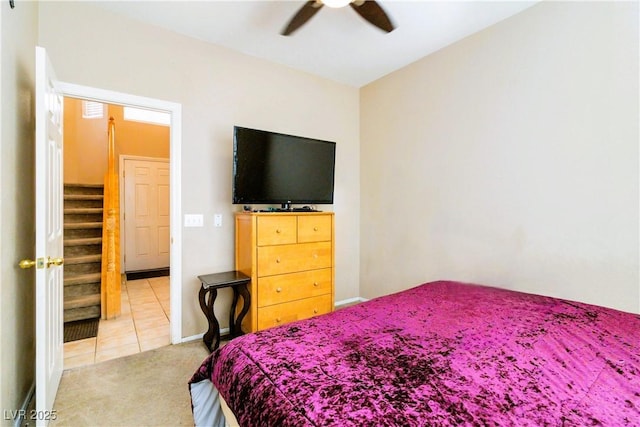 carpeted bedroom with baseboards, ceiling fan, and tile patterned flooring