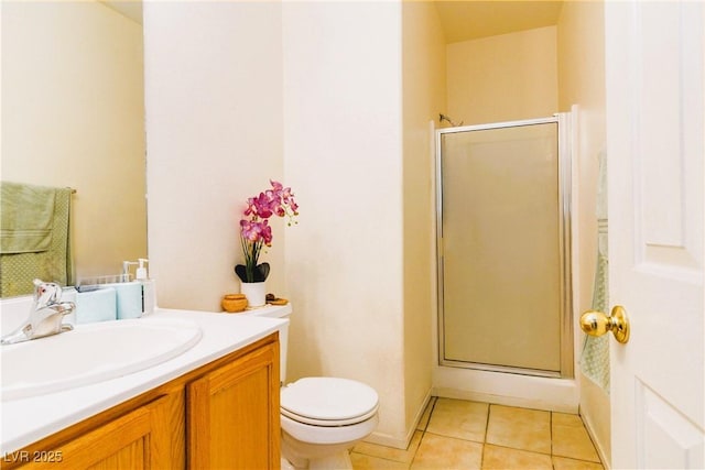 full bathroom with vanity, toilet, a shower stall, and tile patterned flooring