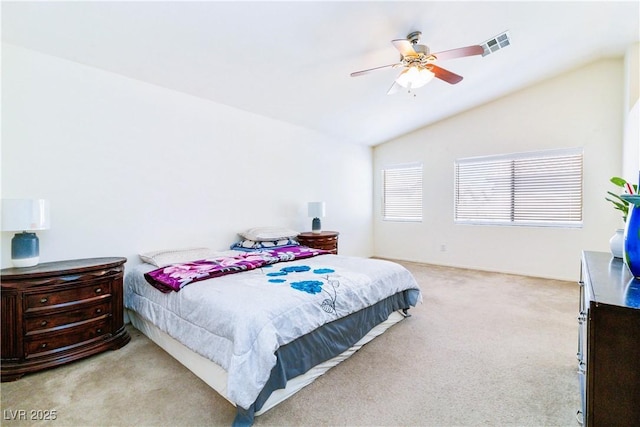 bedroom featuring vaulted ceiling, a ceiling fan, visible vents, and light carpet