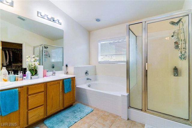 full bath featuring tile patterned flooring, visible vents, double vanity, a stall shower, and a bath