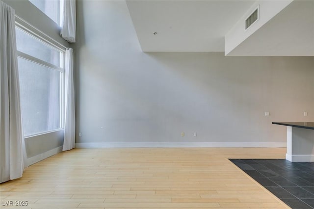 interior space with visible vents, baseboards, and wood finished floors