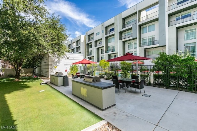 view of patio featuring fence and a grill