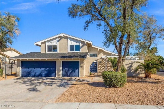 view of front of home featuring stucco siding, driveway, and a garage