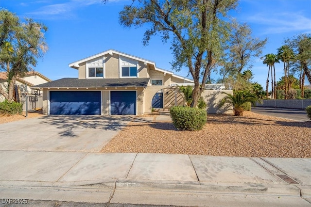 view of front of house with concrete driveway, an attached garage, fence, and stucco siding