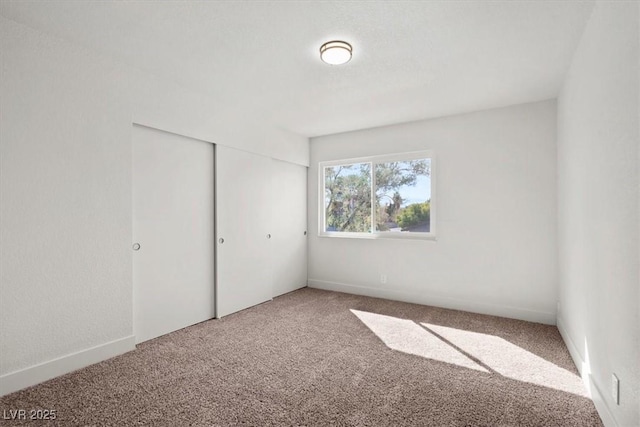 unfurnished bedroom featuring a closet and carpet flooring