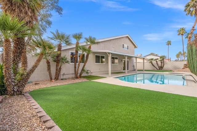 view of swimming pool featuring a yard, a patio, a fenced in pool, and a fenced backyard