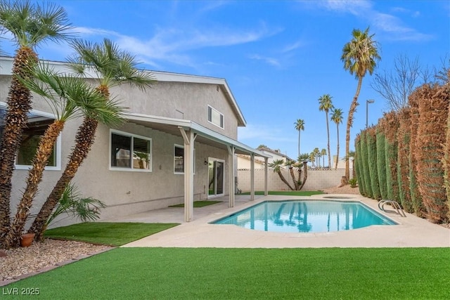 view of swimming pool with a fenced in pool, a patio area, a lawn, and a fenced backyard