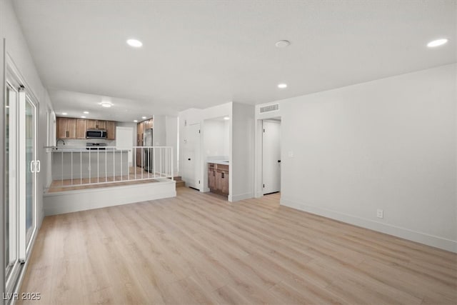 unfurnished living room featuring recessed lighting, visible vents, baseboards, and light wood finished floors